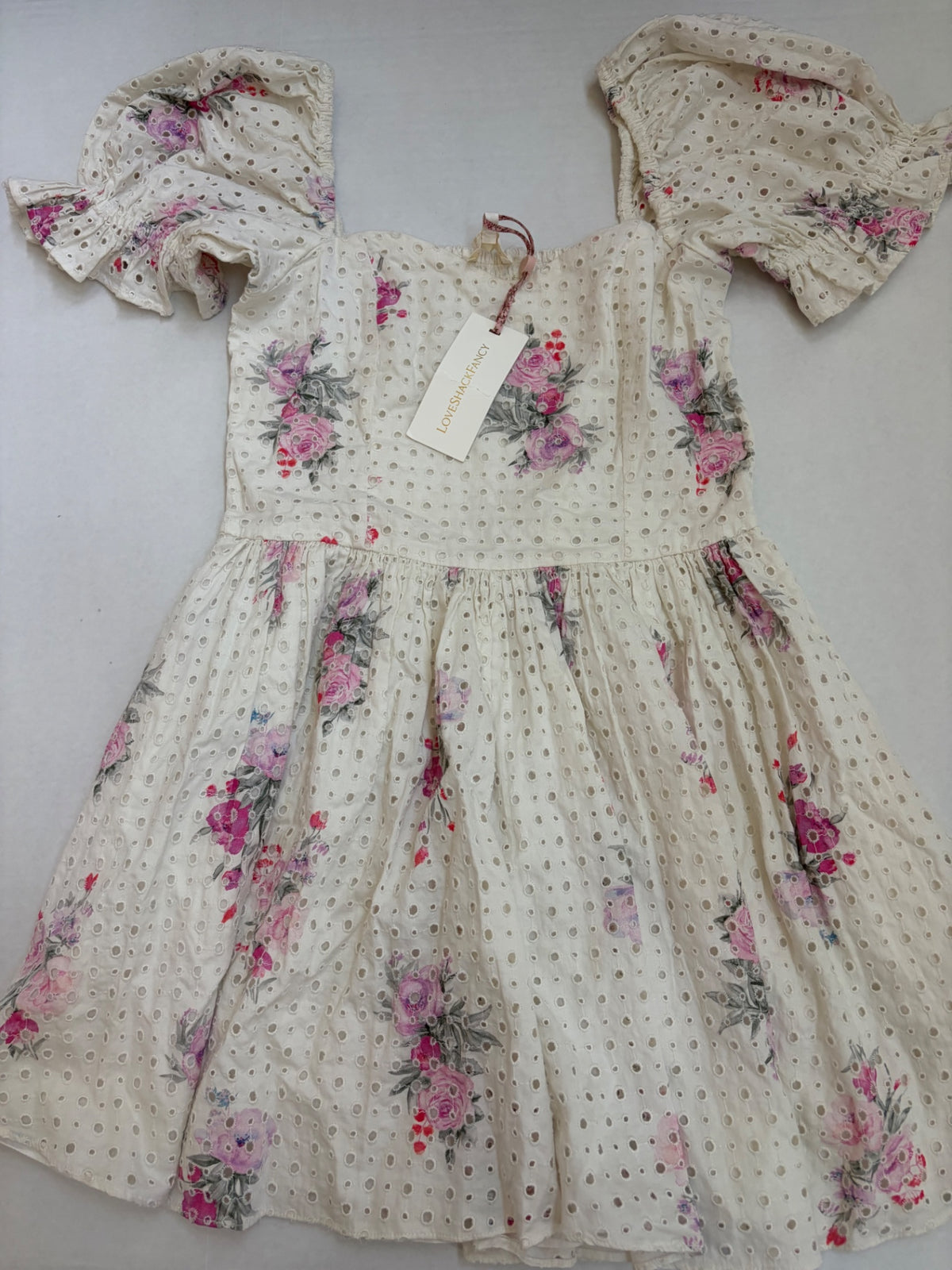 LOVESHACKFANCY Dresses/Rompers Extra Small Off-white/Beige with pink, purple, and gray floral printCotton eyelet fabric with floral print and smocked bodice